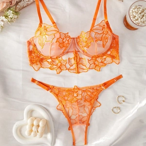 Detailed flat lay of orange floral embroidery lace bra and thong lingerie set