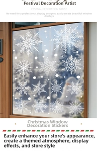 Detailed view of various white snowflake static stickers on a glass window frame