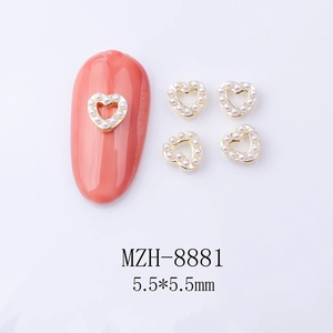 Macro detail of hollow heart nail charms with pearls and golden base size 5.5mm