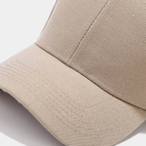 Close-up of khaki cotton twill baseball cap showing precise stitching and fabric texture