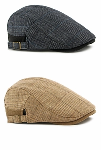 Detailed view of vintage wool tweed flat caps with textured plaid and metal side buckles