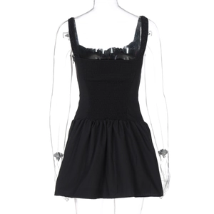 Detailed back view of a black mini dress featuring elastic smocked bodice and pleated hem