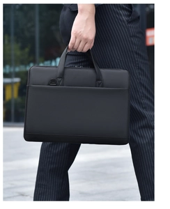 Sleek black waterproof laptop bag with reinforced handles for professional business use
