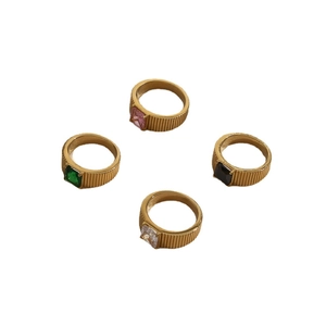 Set of four gold rings with square-cut emerald, pink, black, and clear gemstones