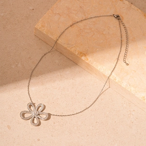 Detailed view of silver flower pendant necklace with cubic zirconia and adjustable chain