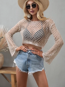 Detail of hollow knit texture and flared sleeves on this beige crochet crop top sweater