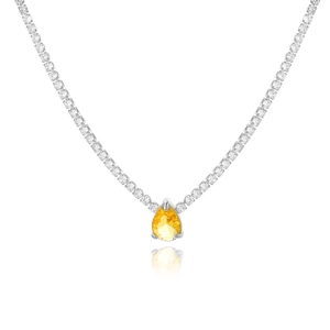 Close-up of silver-tone tennis necklace with a yellow pear-cut zircon pendant on white base