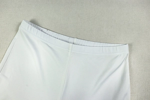 Detail shot of white high-elastic knit waist with tight stitching and flexible waistband