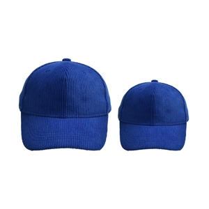 Detailed view of blue corduroy baseball caps in adult and child sizes for family matching