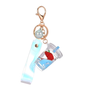 Floating strawberry milk tea keychain with rose gold ring and blue liquid glitter