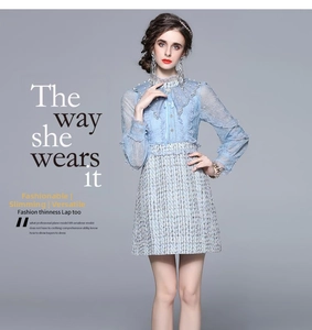 Detail of light blue tweed dress with lace sleeves and embroidery sequins embellishment