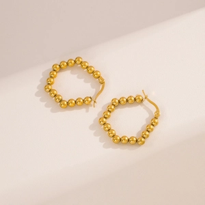 Polished gold stainless steel beaded hoop earrings featuring a minimalist sphere design