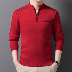 Detail of red men's sweater featuring a quarter-zip mock neck and ribbed cuff textures