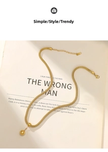 Detail of mesh weave stainless steel necklace with two gold beads and lobster clasp
