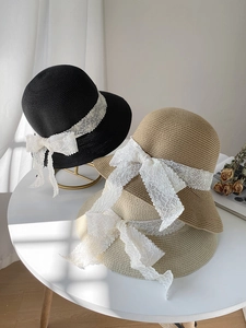 Detailed texture of straw sun hats with elegant lace ribbons and bowknot details