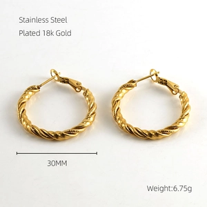 Detail view of 30mm twisted 18k gold plated stainless steel hoop earrings weighing 6.75g