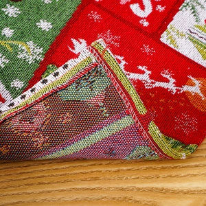 Close-up of festive Christmas placemat fabric with reindeer patterns and stitched edges