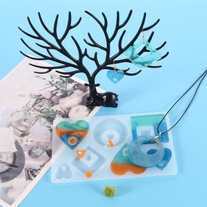 Detail of geometric silicone molds with resin jewelry pendants and earrings