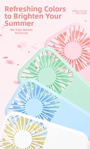Four colorful mini USB fans in pink, green, blue and white on a fresh floral background