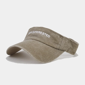 Detail of embroidered Not Interested text on khaki washed cotton sun visor hat