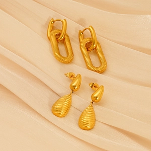 Boucles d'oreilles goutte en or 18 carats et clous à double anneau sur fond de soie