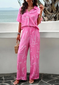 Detail of pink summer two-piece set featuring artistic white print and matching wide-leg pants