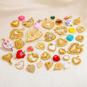 Close-up of assorted heart-shaped enamel and rhinestone titanium steel charms for DIY jewelry