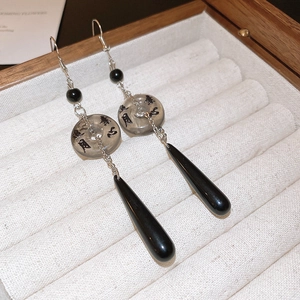 Detail of Chinese ink style drop earrings with calligraphy on transparent rings
