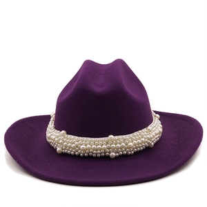 Detail of deep purple wool felt jazz hat featuring a wide band of dense white pearls