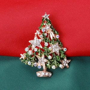 Detailed close-up of a gold-tone Christmas tree brooch with colorful rhinestones