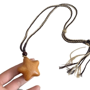 Bohemian woven rope necklace with a handcrafted wooden star pendant and tassel accents