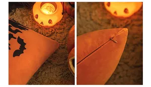 Close-up of Halloween orange velvet pillow cover with bat embroidery and hidden zipper detail