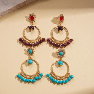 Bohemian dangle earrings with gold rings, purple beads, and turquoise accents