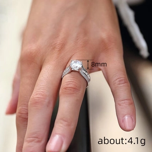 Elegant 4-prong solitaire engagement ring with 8mm round cubic zirconia on hand