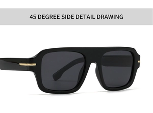 Close-up of square black sunglasses with golden metal hinge accents and dark lenses