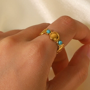 Detailed view of bohemian gold stainless steel ring featuring circular turquoise stones