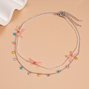 Detail of double-layer necklace with pink bow beads and multicolor crystal charms