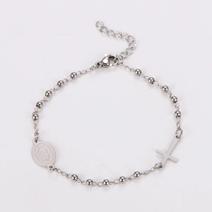 Detail of silver stainless steel bead bracelet featuring a crucifix and virgin mary medal