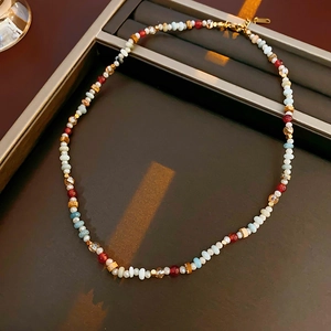Detailed shot of a colorful crystal beaded necklace on a dark display tray