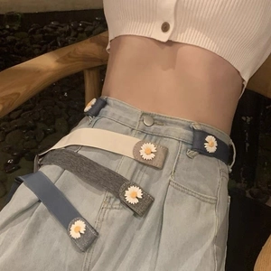 Detail of adjustable elastic waist belt with daisy buckle for tightening jeans on waist