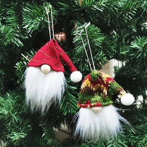 Christmas gnome knit hat ornaments with red polka dots and patterns on a Xmas tree