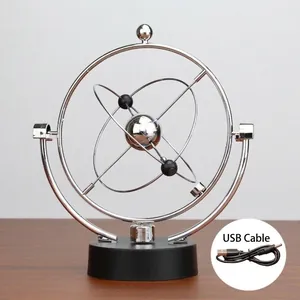 Detail view of kinetic orbital desk toy with metal rings, black base, and USB power cable