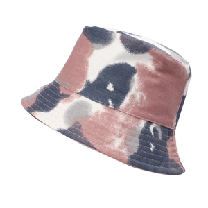 Detail showing pink and blue tie-dye pattern on cotton bucket hat with clean white background