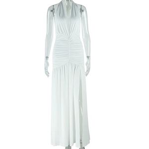 Detail view of white deep V-neck maxi dress with waist pleats and high leg slit