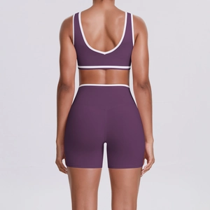 Detail view of purple yoga set featuring a deep U-back tank top and white contrast piping