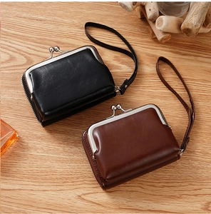 Classic vintage-style kiss-lock coin purses in black and brown faux leather with wrist straps