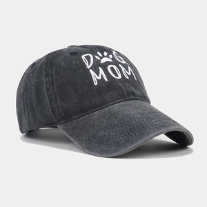 Close-up of Dog Mom embroidery and paw print on washed dark grey cotton baseball cap