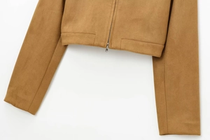 Detailed view of the brown suede jacket texture and metallic silver zipper fastener