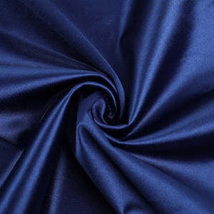 Macro shot of dark blue satin fabric showing silk-like sheen and smooth texture details