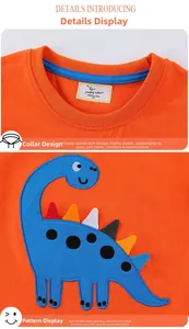 Detail of orange cotton boy t-shirt featuring blue dinosaur embroidery and ribbed crew neck